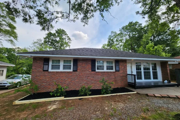 Brick ranch home renovation with new landscaping and deck